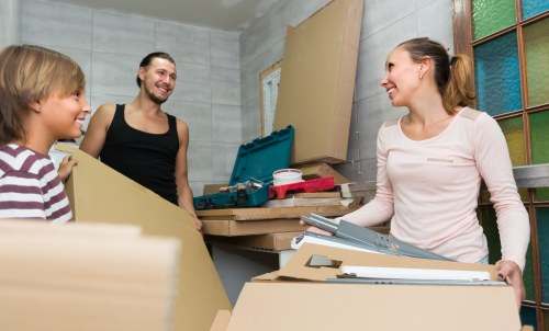 Packing boxes and wrapping household items for a move in Millhill