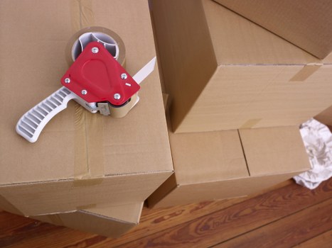 Packed moving boxes and furniture ready for a Millhill property move