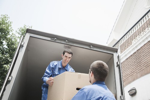 Professional movers loading furniture and packed boxes